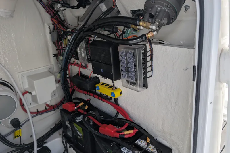 Slide: The Image of Electrical system inside a 2026 Tidewater 2300 Carolina Bay boat, featuring wiring and components. - 20