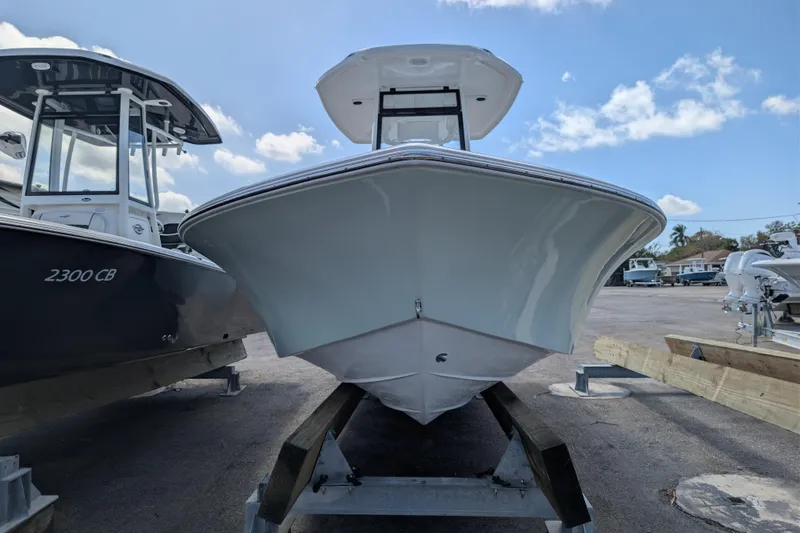 Slide: The Image of 2026 Tidewater 2300 Carolina Bay boat on display under a clear blue sky. - 4