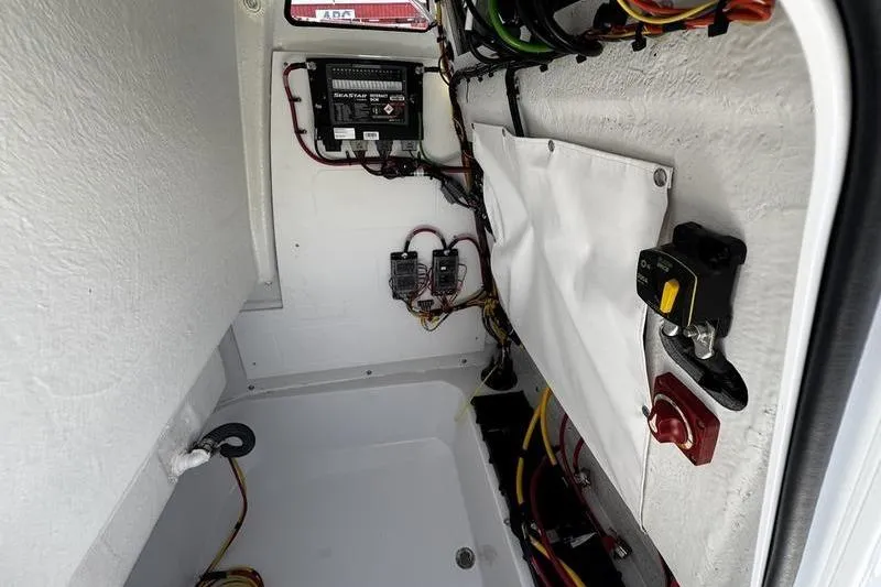 Slide: The Image of 2026 Sportsman Open 212 Center Console electrical compartment with wiring and components. - 13