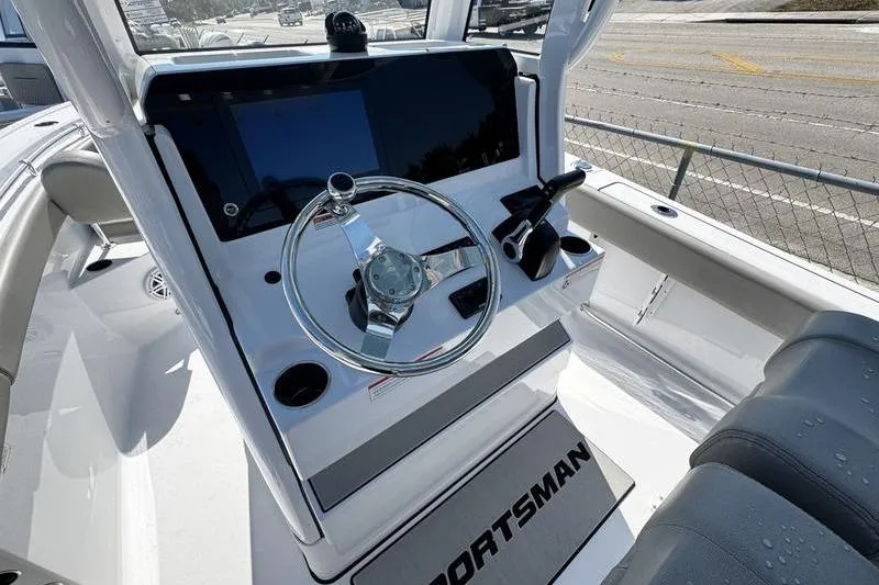 Slide: The Image of 2026 Sportsman Open 212 Center Console boat interior with steering wheel and controls. - 16