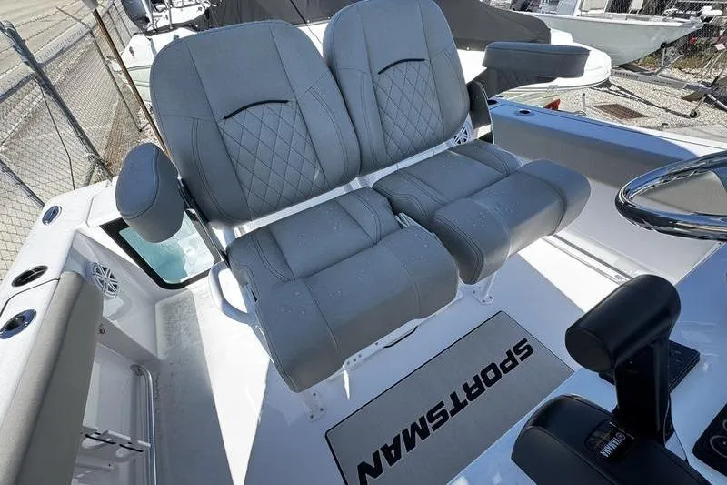 Slide: The Image of 2026 Sportsman Open 212 Center Console boat interior with dual gray seats and steering wheel. - 17