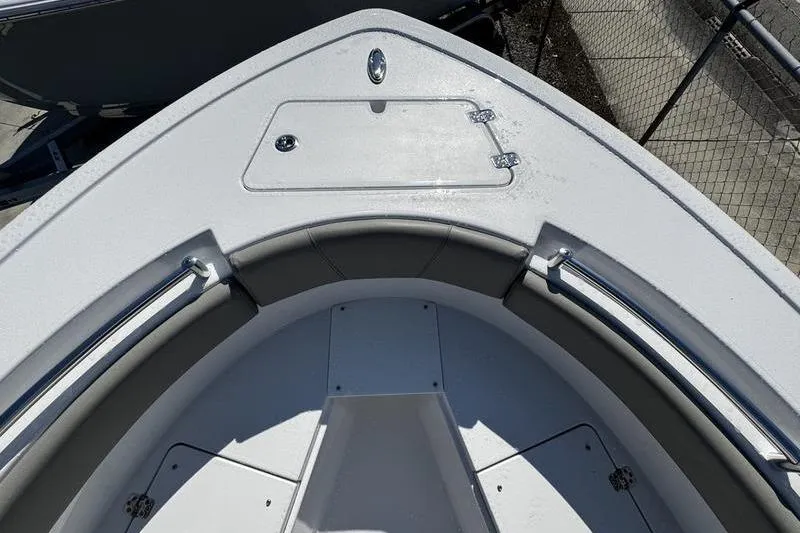 Slide: The Image of 2026 Sportsman Open 212 Center Console boat bow with seating and storage compartment. - 2