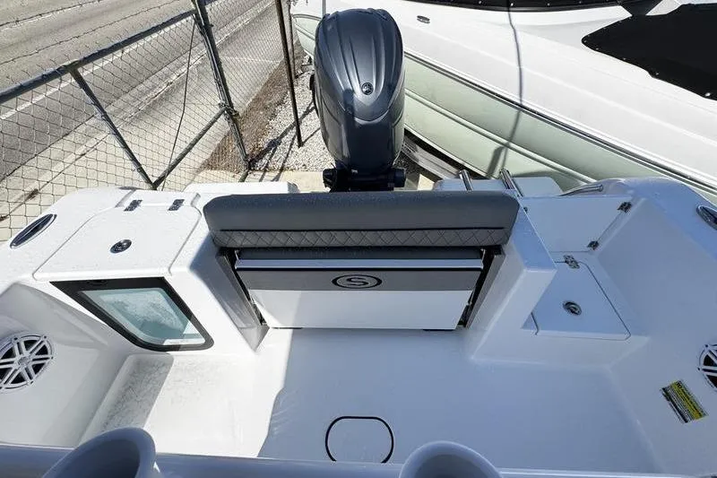 Slide: The Image of 2026 Sportsman Open 212 Center Console boat interior with motor and seating. - 21
