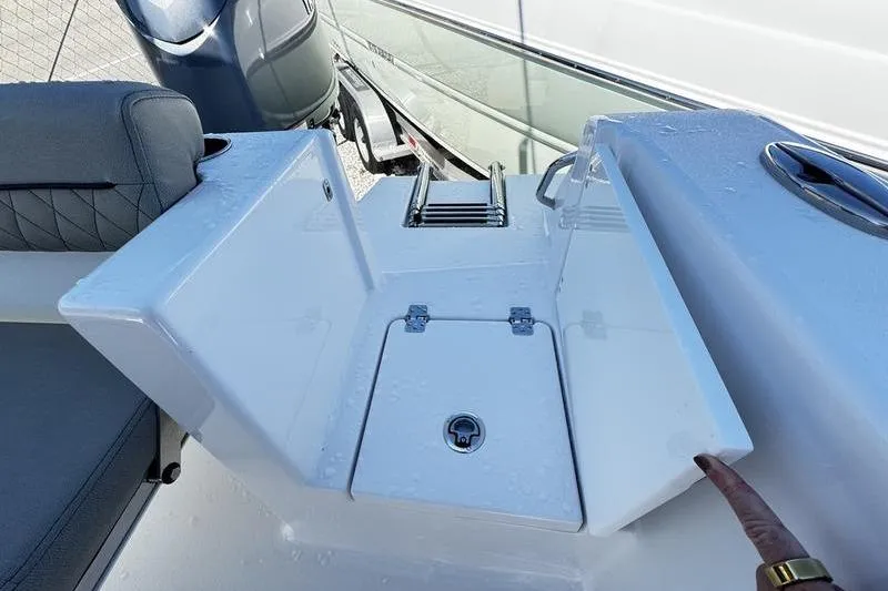 Slide: The Image of 2026 Sportsman Open 212 Center Console boat with seating and storage compartments. - 23