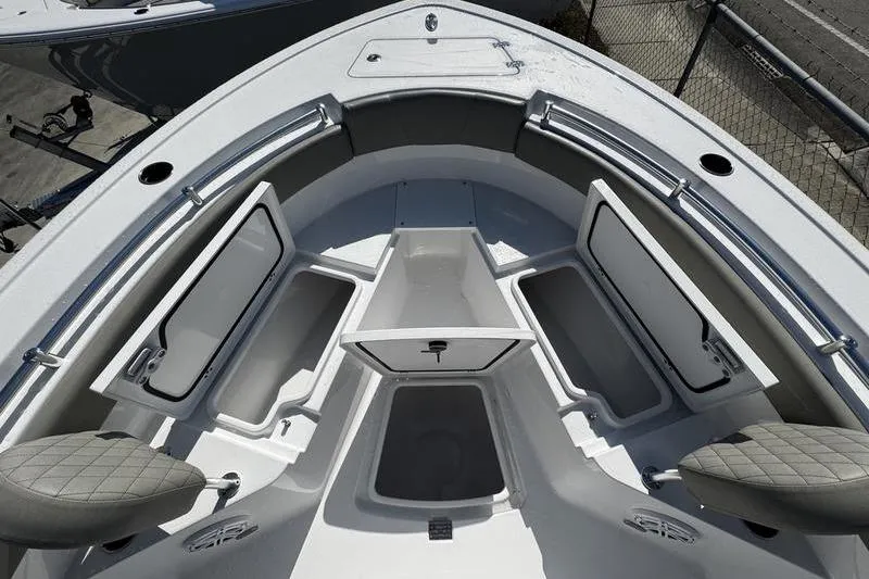 Slide: The Image of 2026 Sportsman Open 212 Center Console boat interior with open storage compartments. - 6