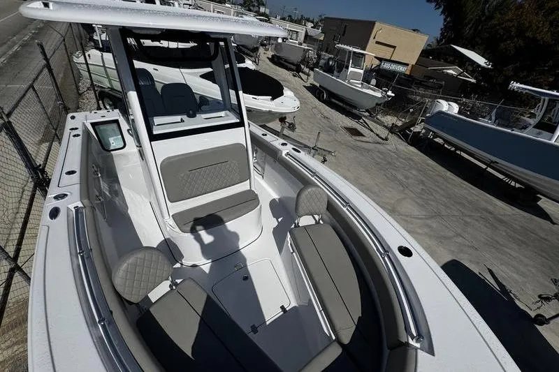 Slide: The Image of 2026 Sportsman Open 212 Center Console boat with seating, docked in a marina. - 9