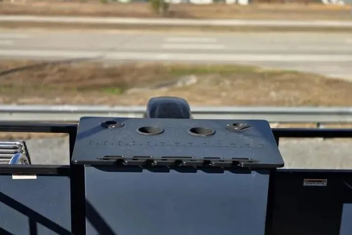 Slide: The Image of 2021 Misty Harbor Del Mar 18F boat dashboard with cup holders and controls. - 14