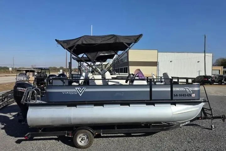 Slide: The Image of 2021 Misty Harbor Del Mar 18F pontoon boat with canopy on trailer, outdoor setting. - 9