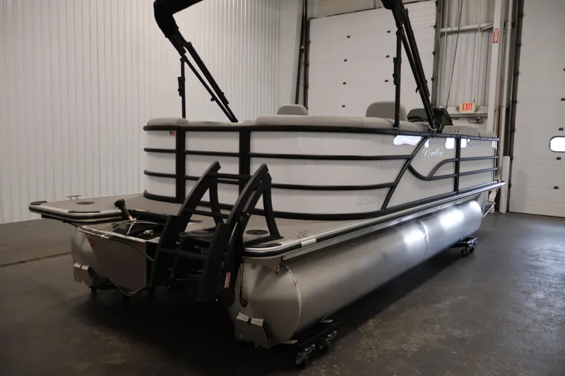 Slide: The Image of 2026 Bentley Pontoons Legacy 200 Navigator in a showroom, showcasing sleek design and modern features. - 4