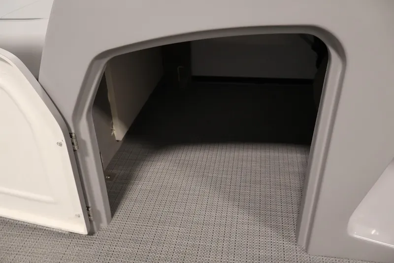 Slide: The Image of 2026 Bentley Pontoons Legacy 200 Navigator storage compartment with open door, showcasing interior space. - 16