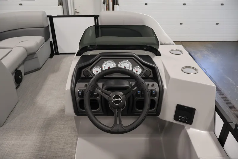 Slide: The Image of 2026 Bentley Pontoons Legacy 200 Navigator dashboard with steering wheel and gauges in a sleek interior. - 17