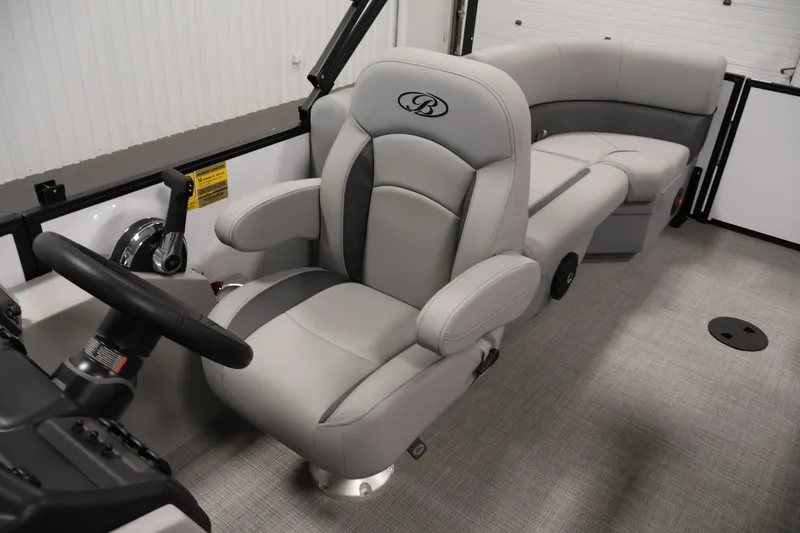 Slide: The Image of 2026 Bentley Pontoons Legacy 200 Navigator interior with luxurious seating and steering console. - 24