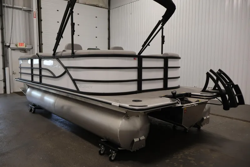 Slide: The Image of 2026 Bentley Pontoons Legacy 200 Navigator in a showroom, showcasing sleek design and modern features. - 6