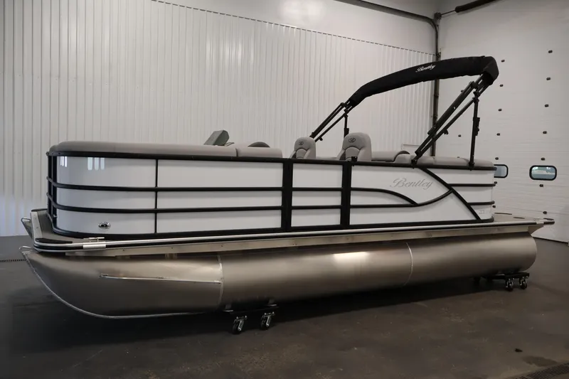 Slide: The Image of 2026 Bentley Pontoons Legacy 200 Navigator in a showroom, showcasing sleek design and modern features. - 7