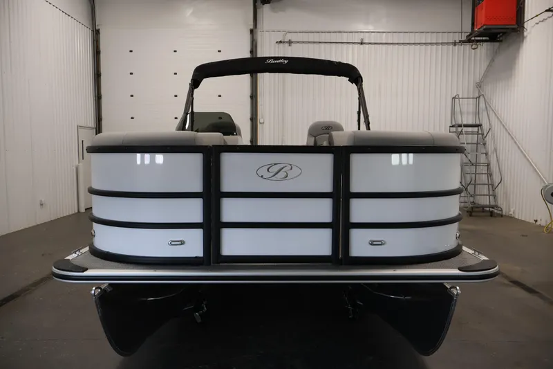 Slide: The Image of 2026 Bentley Pontoons Legacy 200 Navigator in a showroom, front view. - 1