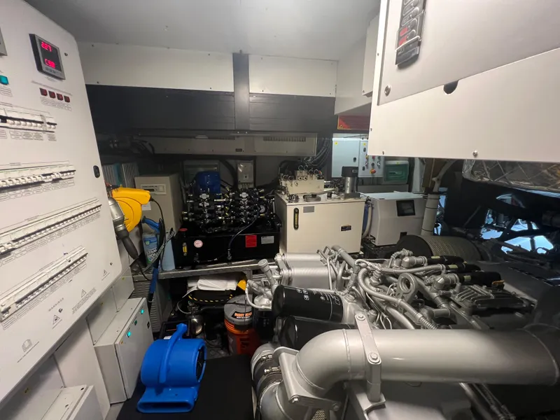 Slide: The Image of Engine room of 2017 Pershing 92 Motor Yacht with complex machinery and control panels. - 16