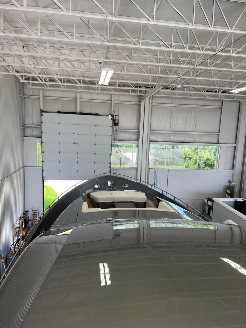 Slide: The Image of 2017 Pershing 92 Motor Yacht in a spacious indoor storage facility. - 29