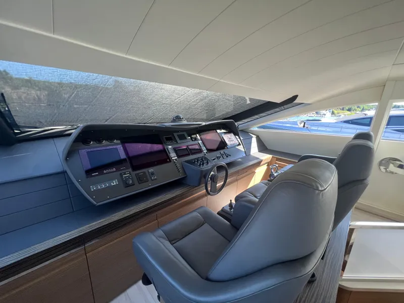 Slide: The Image of Cockpit of 2017 Pershing 92 Motor Yacht with modern navigation controls and leather seating. - 36