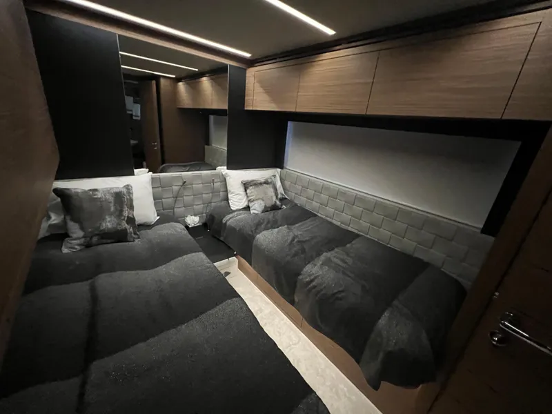 Slide: The Image of Luxurious twin bedroom in 2017 Pershing 92 Motor Yacht with modern decor and ambient lighting. - 42