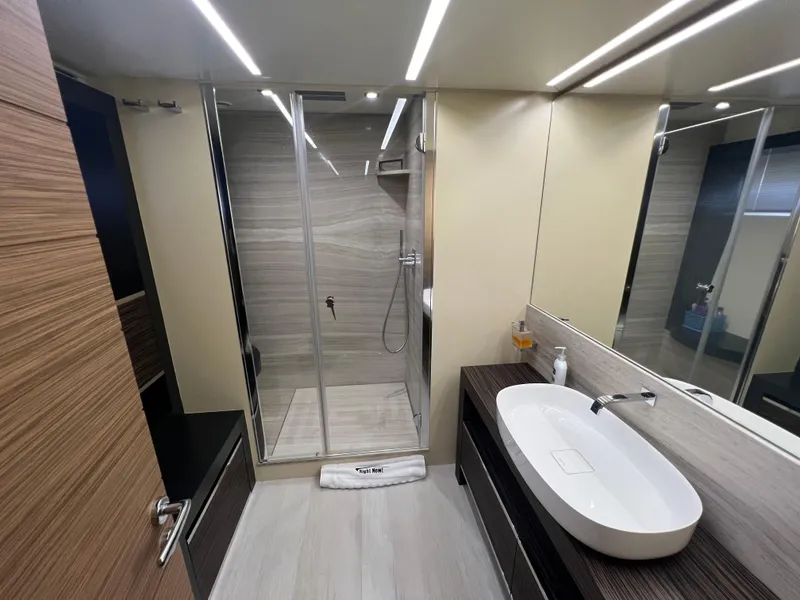 Slide: The Image of Luxurious bathroom on 2017 Pershing 92 Motor Yacht with modern shower and sleek sink design. - 48