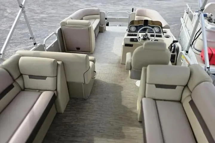 Slide: The Image of 2021 Godfrey Sweetwater 2086 BF pontoon boat interior with beige seating and steering console. - 11