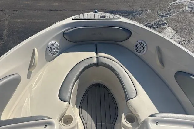 Slide: The Image of 2008 Sea Ray 205 Sport boat interior with cushioned seating and speakers. - 10