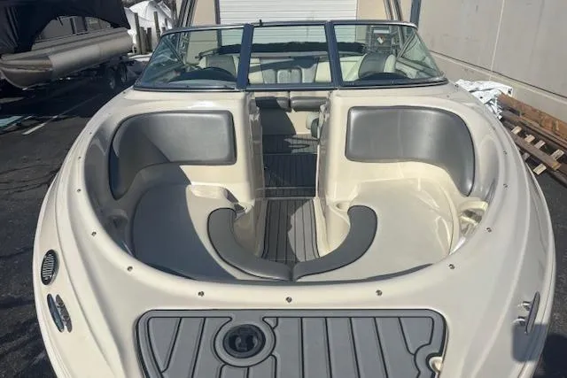 Slide: The Image of 2008 Sea Ray 205 Sport boat interior with gray seating and open bow design. - 6