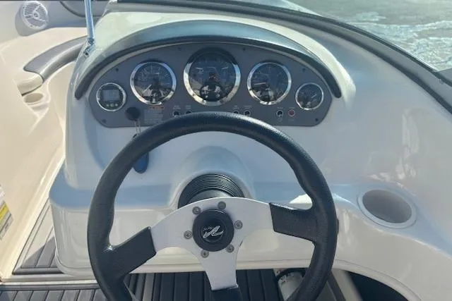 Slide: The Image of Steering wheel and dashboard of 2008 Sea Ray 205 Sport boat, featuring gauges and controls. - 8