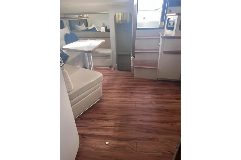 Slide: The Image of Interior of 1990 Carver 528 Montego yacht with wood flooring and seating area. - 10