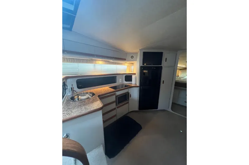 Slide: The Image of Interior of 1990 Carver 528 Montego yacht with kitchenette and modern amenities. - 12