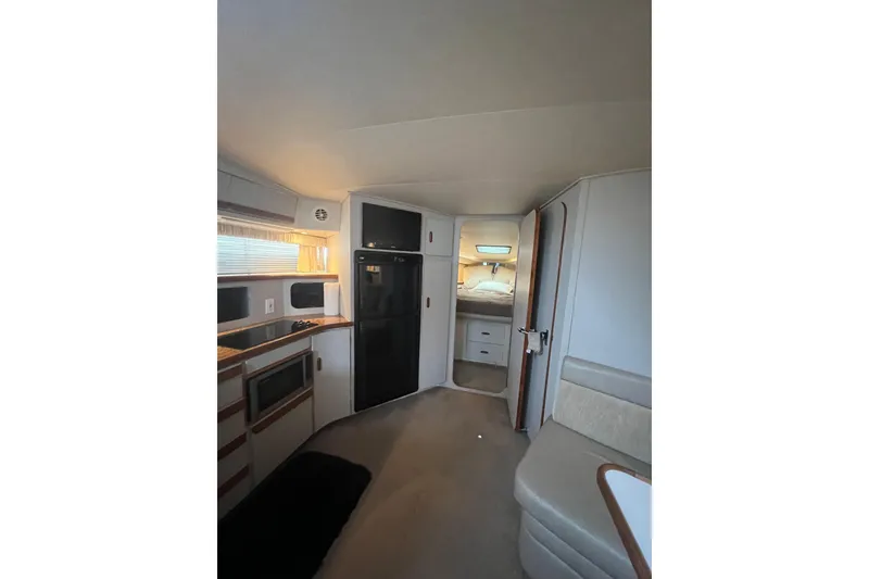Slide: The Image of Interior of 1990 Carver 528 Montego boat with kitchen and sleeping area. - 13