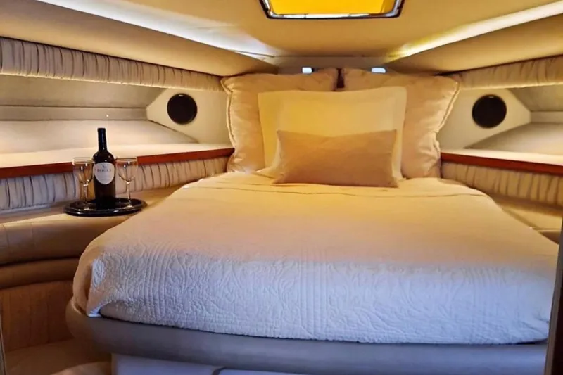 Slide: The Image of Luxurious cabin interior of 1990 Carver 528 Montego yacht with cozy bed and wine setup. - 14
