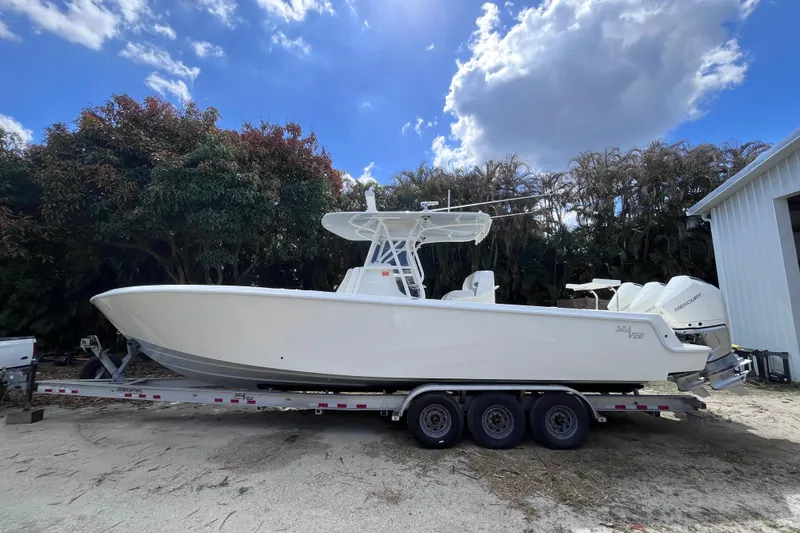 The Image of 2021 SeaVee 340B Open boat on trailer, parked outdoors under a cloudy sky. - 0