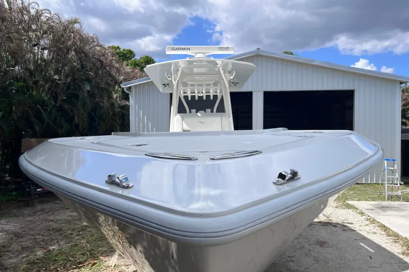Slide: The Image of 2021 SeaVee 340B Open boat in front of a storage building under a cloudy sky. - 10