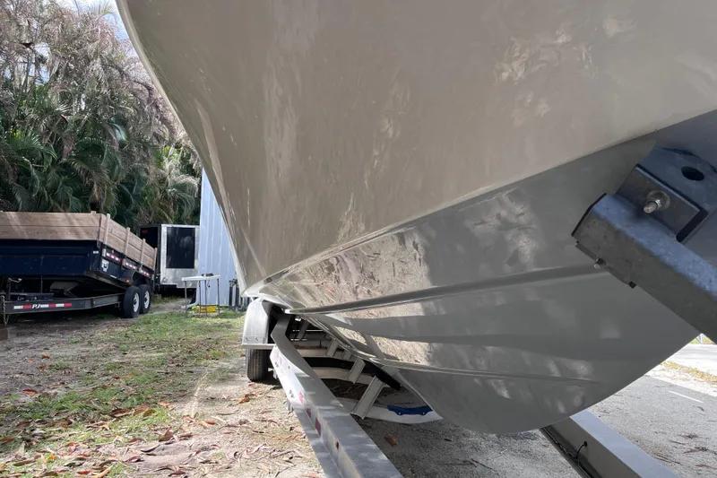 Slide: The Image of 2021 SeaVee 340B Open boat on trailer, surrounded by trees and equipment. - 13