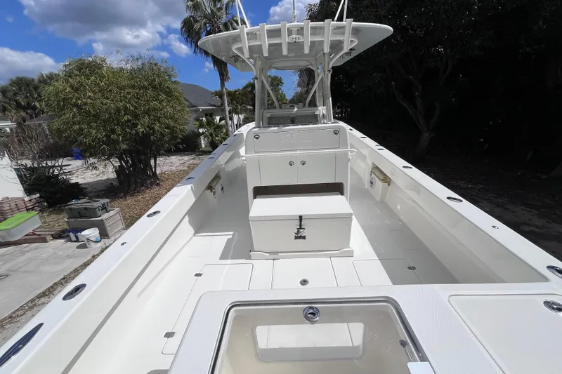 Slide: The Image of 2021 SeaVee 340B Open boat with spacious deck and storage, surrounded by lush greenery. - 14