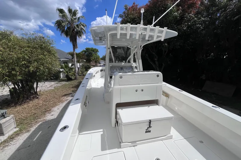 Slide: The Image of 2021 SeaVee 340B Open boat with center console, docked near tropical foliage. - 15