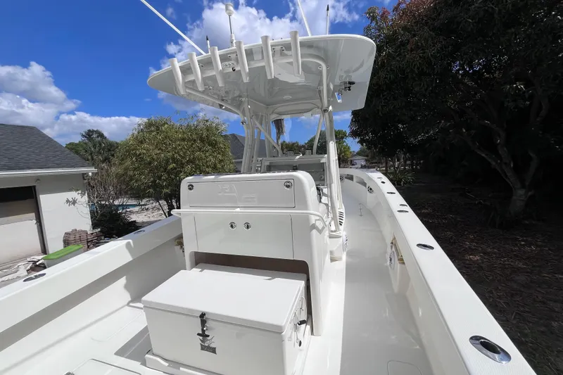 Slide: The Image of 2021 SeaVee 340B Open boat with T-top, white deck, and storage box. - 16