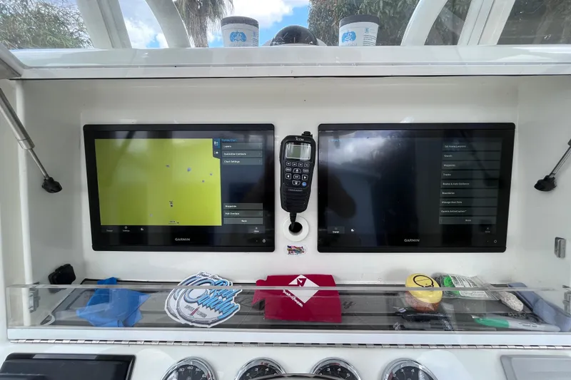 Slide: The Image of 2021 SeaVee 340B Open dashboard with dual Garmin displays and communication equipment. - 22