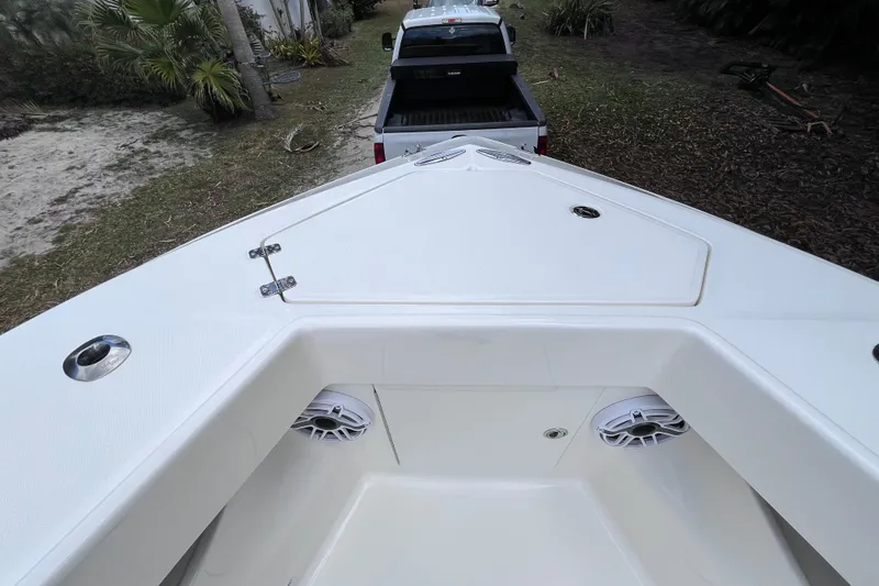 Slide: The Image of 2021 SeaVee 340B Open boat bow with speakers, parked near a pickup truck. - 26