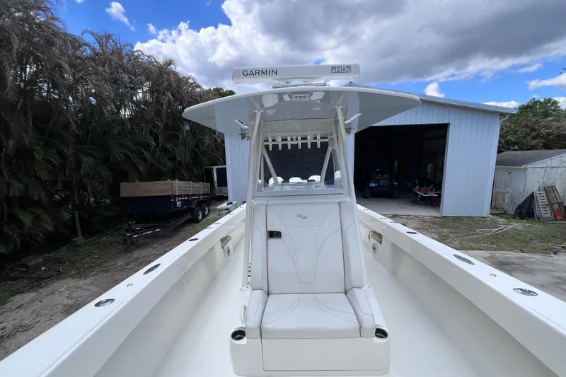 Slide: The Image of 2021 SeaVee 340B Open boat with Garmin radar, parked near a shed under cloudy skies. - 28