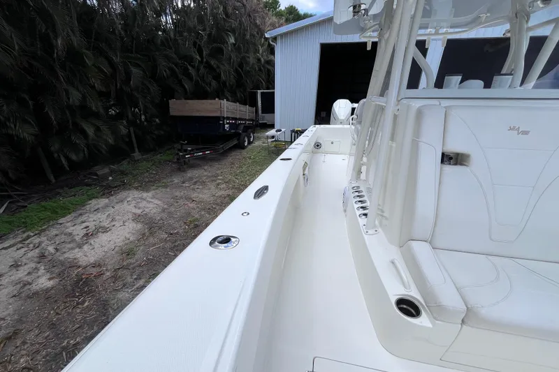 Slide: The Image of 2021 SeaVee 340B Open boat, white interior, parked near a shed and trailer. - 29