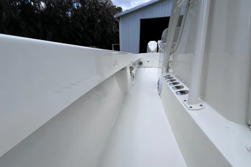Slide: The Image of 2021 SeaVee 340B Open boat interior, showcasing sleek white deck and rod holders. - 30