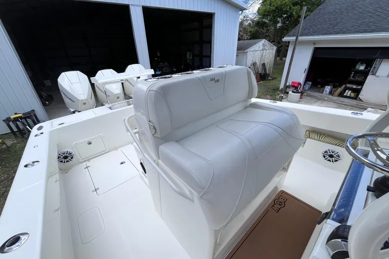 Slide: The Image of 2021 SeaVee 340B Open boat interior with seating and triple outboard engines. - 32