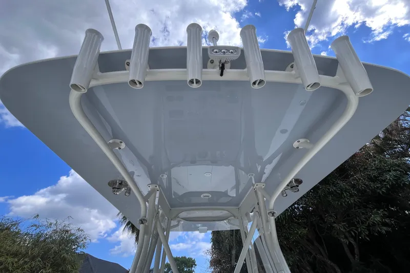 Slide: The Image of 2021 SeaVee 340B Open boat T-top with rod holders against blue sky. - 41