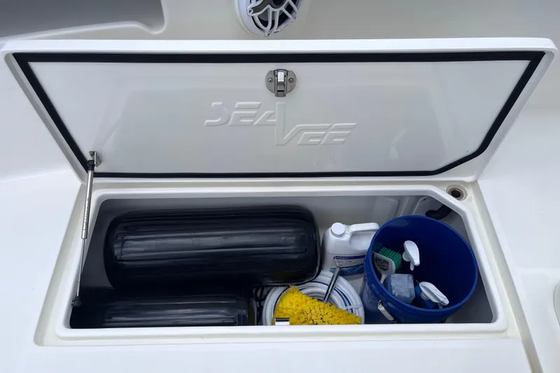 Slide: The Image of Open storage compartment on 2021 SeaVee 340B Open boat with cleaning supplies and equipment. - 47