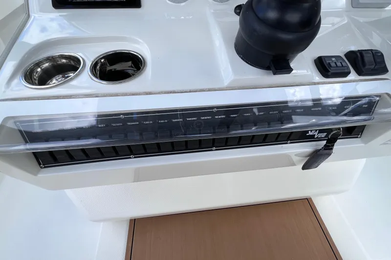 Slide: The Image of 2021 SeaVee 340B Open boat dashboard with controls and cup holders. - 52