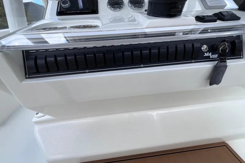 Slide: The Image of 2021 SeaVee 340B Open boat dashboard with control panel and key. - 53