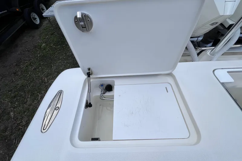 Slide: The Image of Open storage compartment on 2021 SeaVee 340B Open boat, featuring a hydraulic lift. - 58