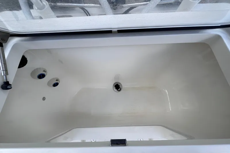 Slide: The Image of Livewell compartment of 2021 SeaVee 340B Open boat, featuring drainage and aeration systems. - 59